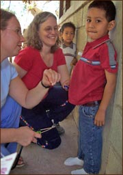 Candace Kugel visits with a child in Honduras