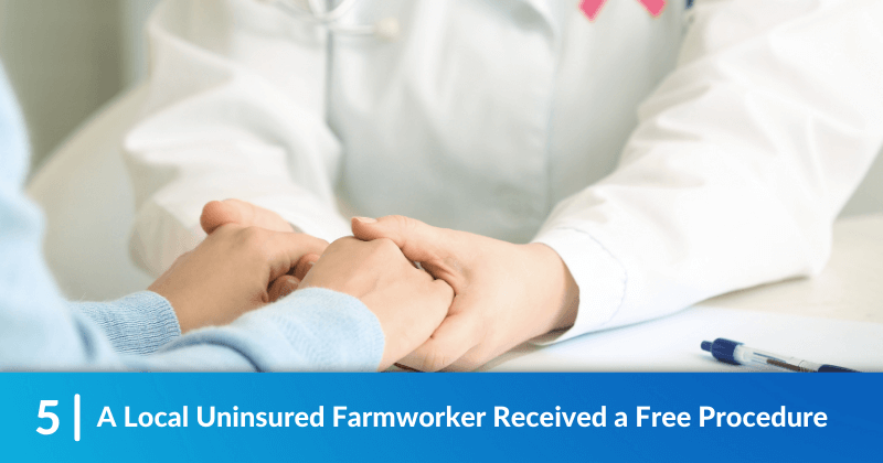 A clinician supportively holds the hands of their patient. Heading reads, A Local Uninsured Farmworker Received a Free Procedure.