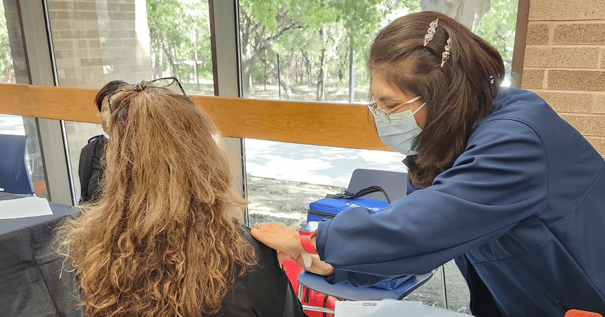 Volunteer providing patient with a vaccine.